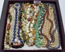 A selection of vintage strings of beads including mother of pearl, polished mineral, glass,