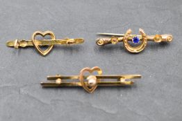 Three yellow metal bar brooches, (two stamped 9ct) of various forms, approx 3g AF