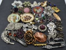 A selection of costume jewellery brooches including mosaic, Celtic style, Miracle, marcasite etc