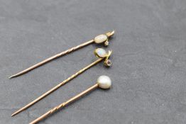 An opal and diamond chip stick pin, another similar having an opal and small amethyst, both in