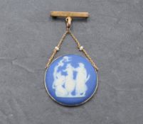 A Wedgwood Erturia blue cameo brooch depicting a scene from the Birth & dipping of Achilles in a