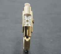A ladies 18ct gold cocktail watch having baton and Arabic numeral dial to rectangular face in gold