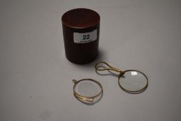 Two early 20th century optical monocle one having grip handle both in yellow metal frames with case
