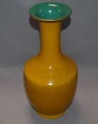 A Qing dynasty baluster vase having yellow imperial style glaze and bearing character seal mark to