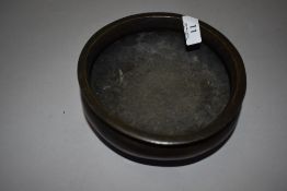 A Chinese bronze temple censor or incense burner of plain form with three footed base bearing seal