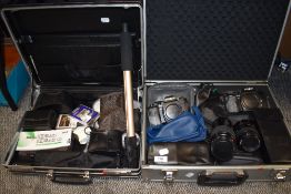Two hard bodied case containing photographic equipment including two Minolta 9000 and zoom 75-300