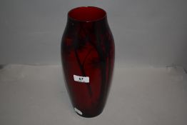 An early 20th century pottery vase by Royal Doulton in a flambe glaze with woodland scene