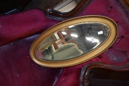 A gilt frame oval wall mirror, approx. 66 x 33cm
