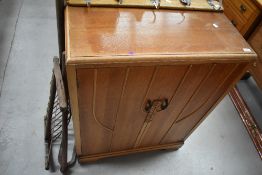 A 20th century light oak utility cupboard