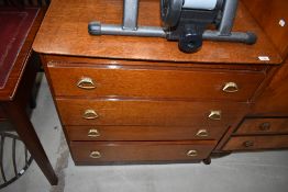 A mid century medium stained oak chest of four drawers