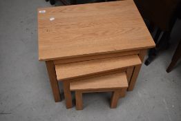 A modern nest of three light oak side or coffee tables