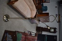 A modern polished brass reading lamp