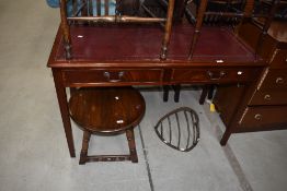 A modern office desk having mahogany frame with ox blood leather top