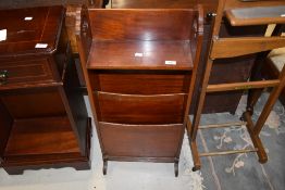 An Arts and Crafts mahogany magazine rack with shelf over, in the Arthur Simpson style, width