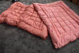 Two vintage rose pink single eiderdowns.