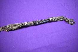 A late Georgian/early Victorian misers purse having original cut steel bands.