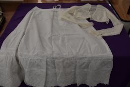An antique petticoat having cutwork and pin tuck detailing sold with a fine tulle lace jacket.