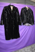 A black 1930s full length moleskin or similar coat and a shorter example,around 1950s,damage to