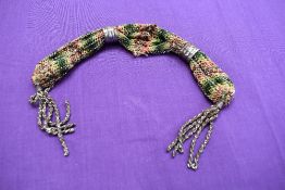 An antique misers purse having original metal cuffs.