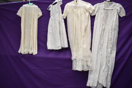 A collection of antique childrens clothing including fine silk gown.
