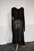 A 1930s black lace and georgette dress having full length sleeves and panelled skirt.