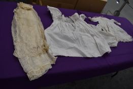 A small collection of intricate childrens garments.