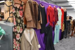 A selection of mixed vintage coats and dresses, various styles and eras.