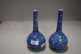 A pair of transfer-printed blue and white bottle vases, in the Chinese style 18cm