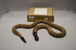 An unusual antique folk art style hand made snake made from stamps