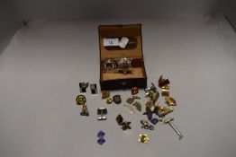 A selection of gentleman's cuff links and enamel pin badges