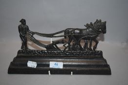 A vintage cast iron door stop in the form of ploughman inscribed for Burns