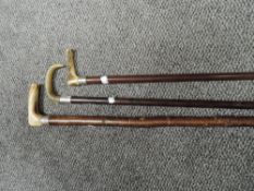 Three horn handled walking sticks one having HM silver band