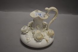 A mid 19th century Derby Blanc de Chine ewer, having rose encrusted body, Stevenson,sharp and Co