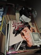 A selection of vinyl records and books including Elton John etc