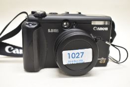 A Canon G5 Powershot camera with remote, charger and soft bag