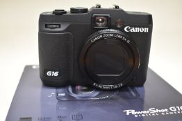 A Canon Powershot G16 digital camera in original box with battery and charger