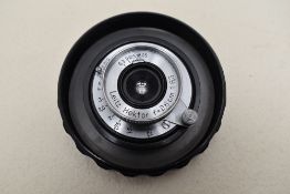 A Leica (Leitz) 2.8cm 1:6,3 lens in case, circa 1939