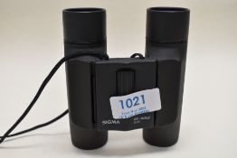 A pair of Sigma high contrast 10x25 binoculars
