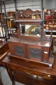 A Victorian mahogany hall or toilet mirror having Lincustra style panelled doors , self supporting