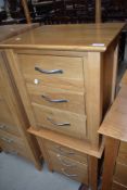 A pair of modern golden oak bedside chests