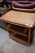 An Ercol tea trolley mid to light colour