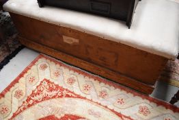 A traditional bedding box, pine with overstuffed top , width approx. 122cm Bearing label for