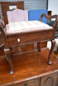 An early 20th Century piano stool with later top