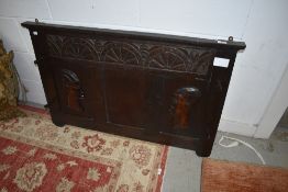 An antique wall mounted hat or coat rack having tribal styling.