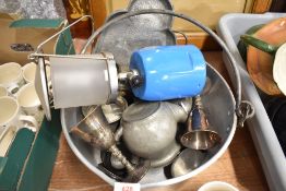 A jam pan with a selection of metal wares and gas lamp
