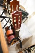Three acoustic guitars and a guitar stand