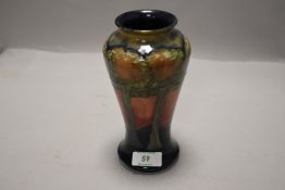 A Moorcroft Eventide vase having autumnal toned ground with tube lined tree decoration, some minor