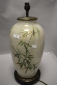 A modern glass table lamp having bamboo pattern with wooden base.
