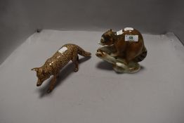 A Gerold Porzellan, Barvaria Racoon and a wolf in brown gloss marked Tom Mackie.