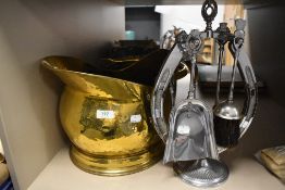An antique helmet style coal bucket having hammered brass finish